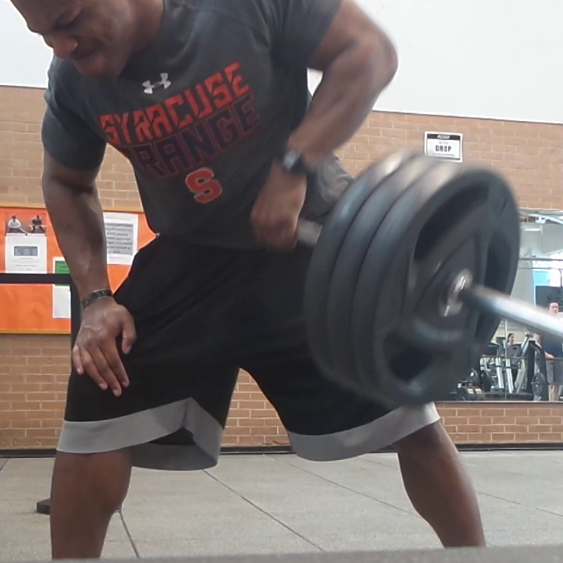 me doing single barbell rows in a gym wearing a Syracuse Orange shirt