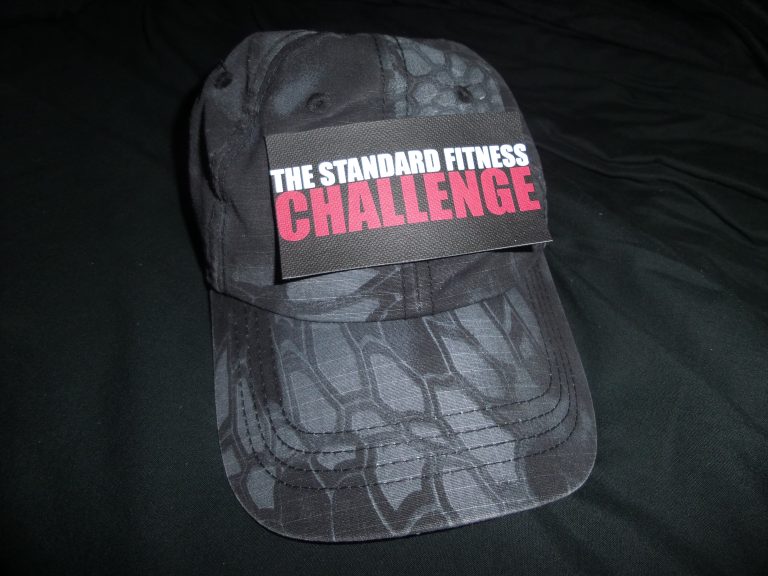 The Standard Fitness Challenge velcro patch on a black baseball cap